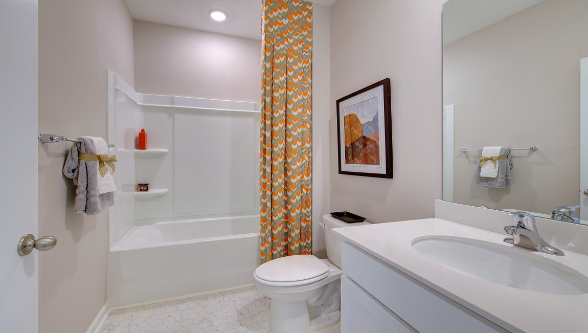 Bathroom with single vanity and bathtub