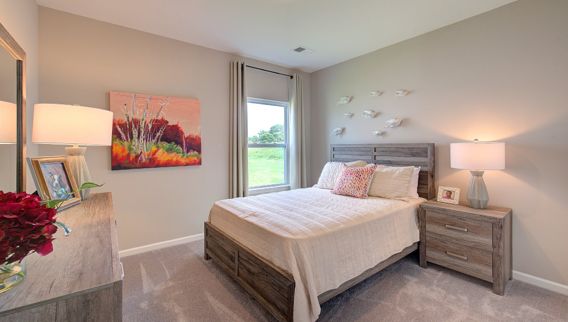 Carpeted bedroom with large windows