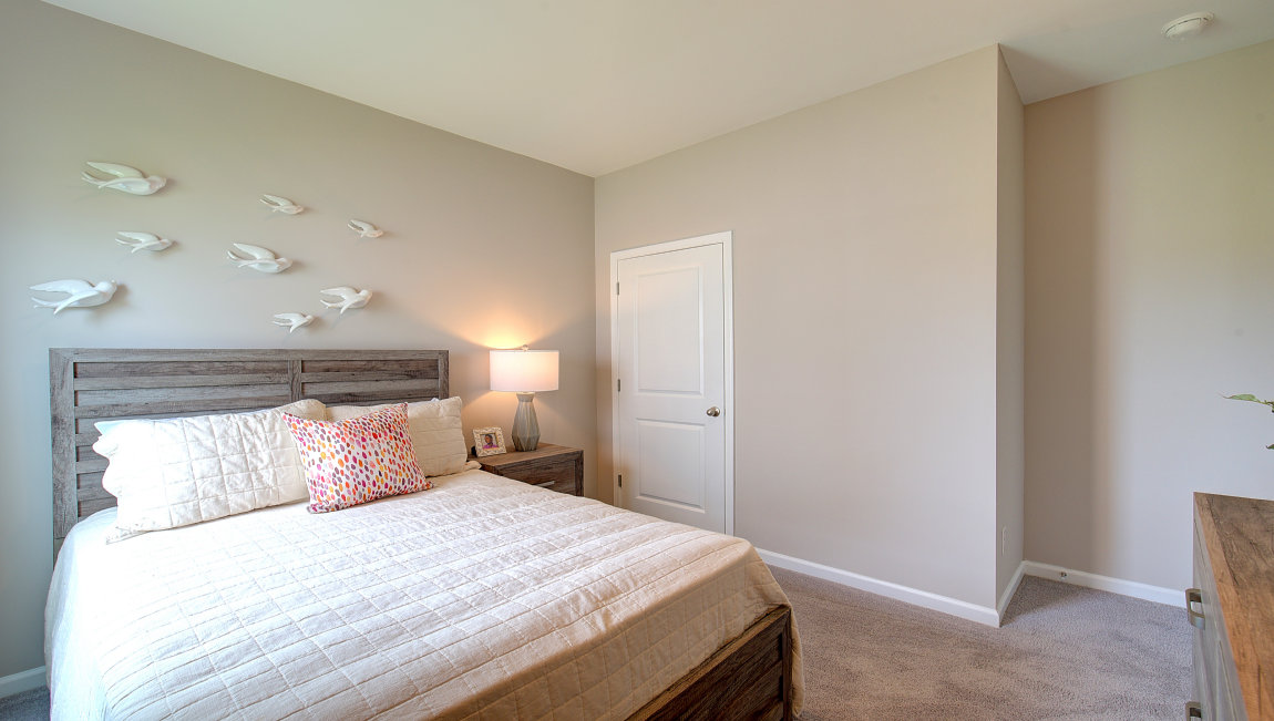 Carpeted bedroom with large windows