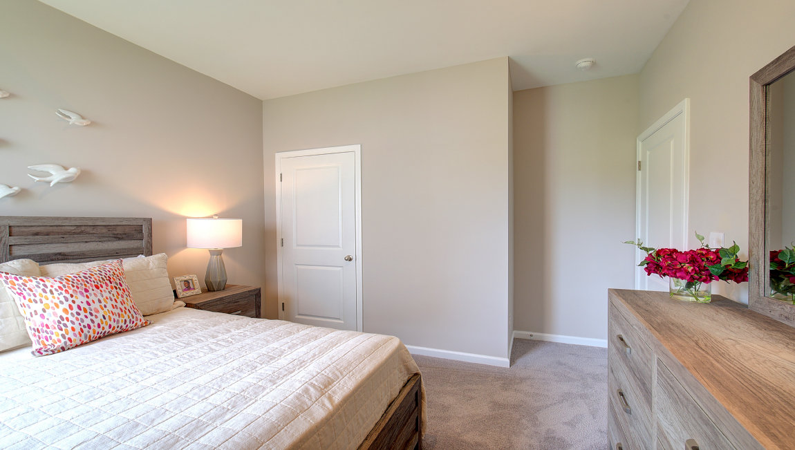 Carpeted bedroom with large windows
