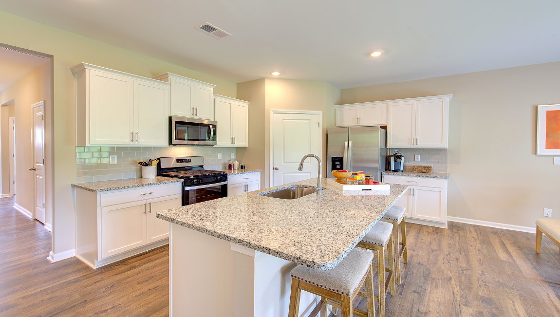 Open concept kitchen with large island and stainless steel appliances