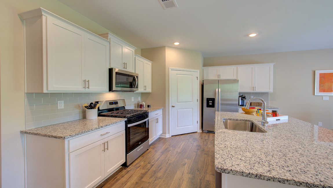 Open concept kitchen with large island and stainless steel appliances