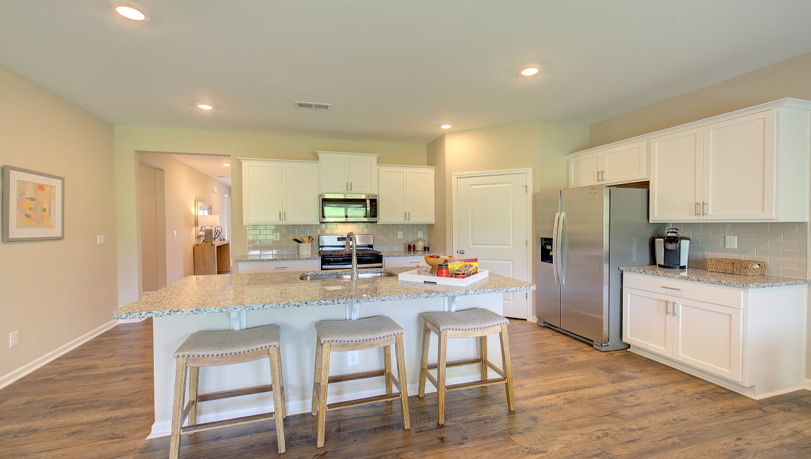 Open concept kitchen with large island and stainless steel appliances