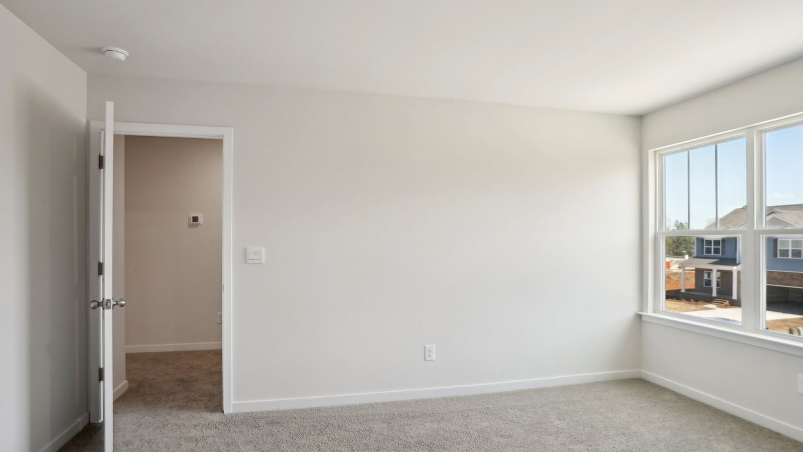 Carpeted bedroom with windows