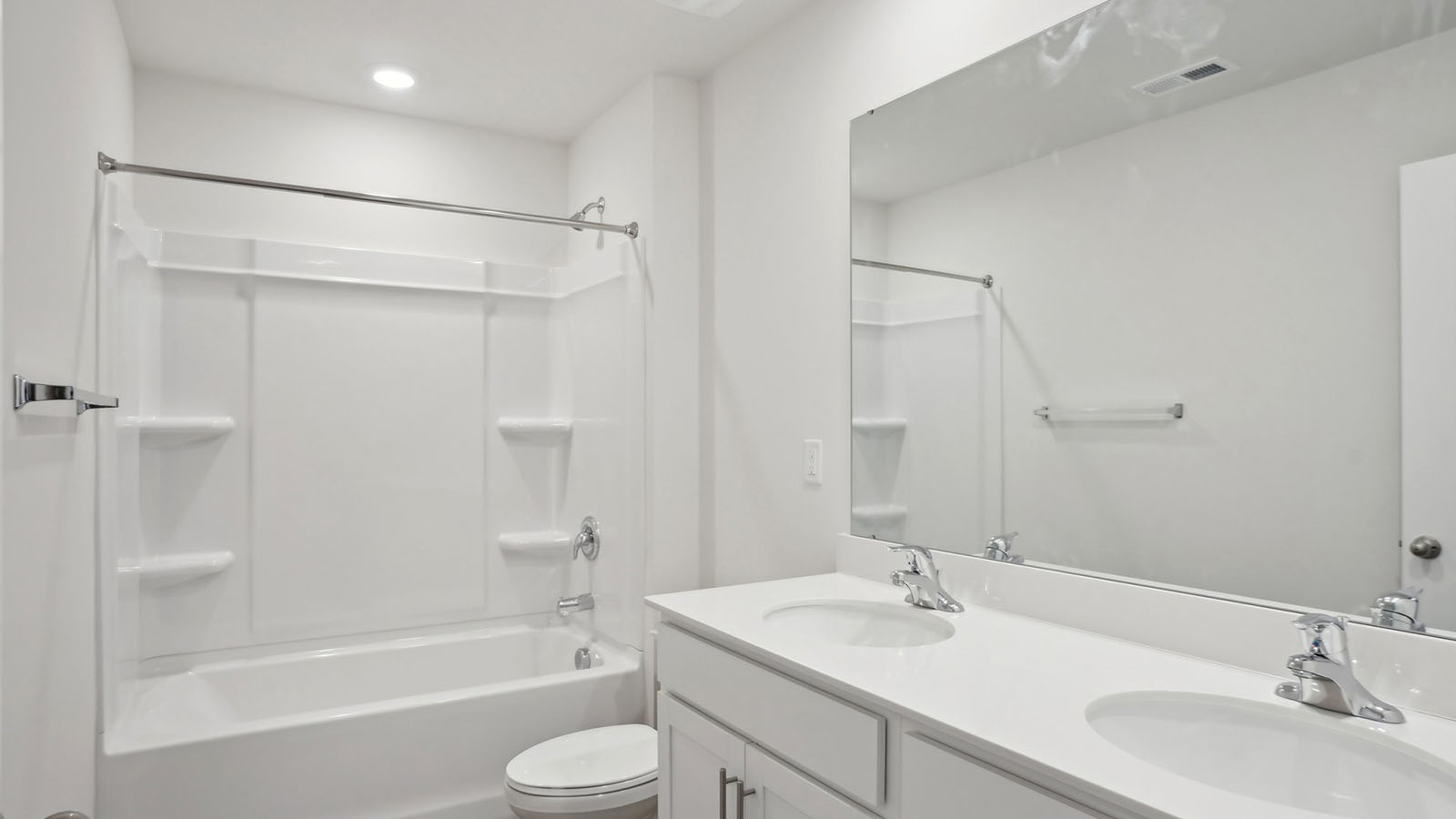 Bathroom with double vanity and bathtub