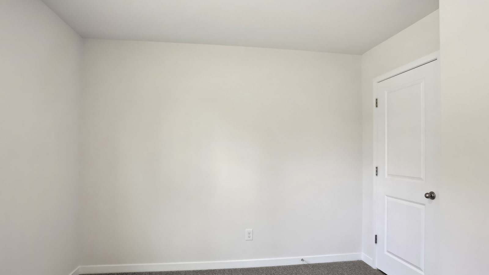 Carpeted bedroom with windows