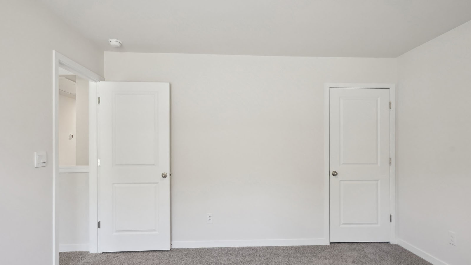 Carpeted bedroom with windows