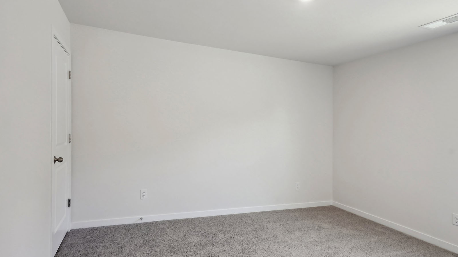 Carpeted bedroom with windows