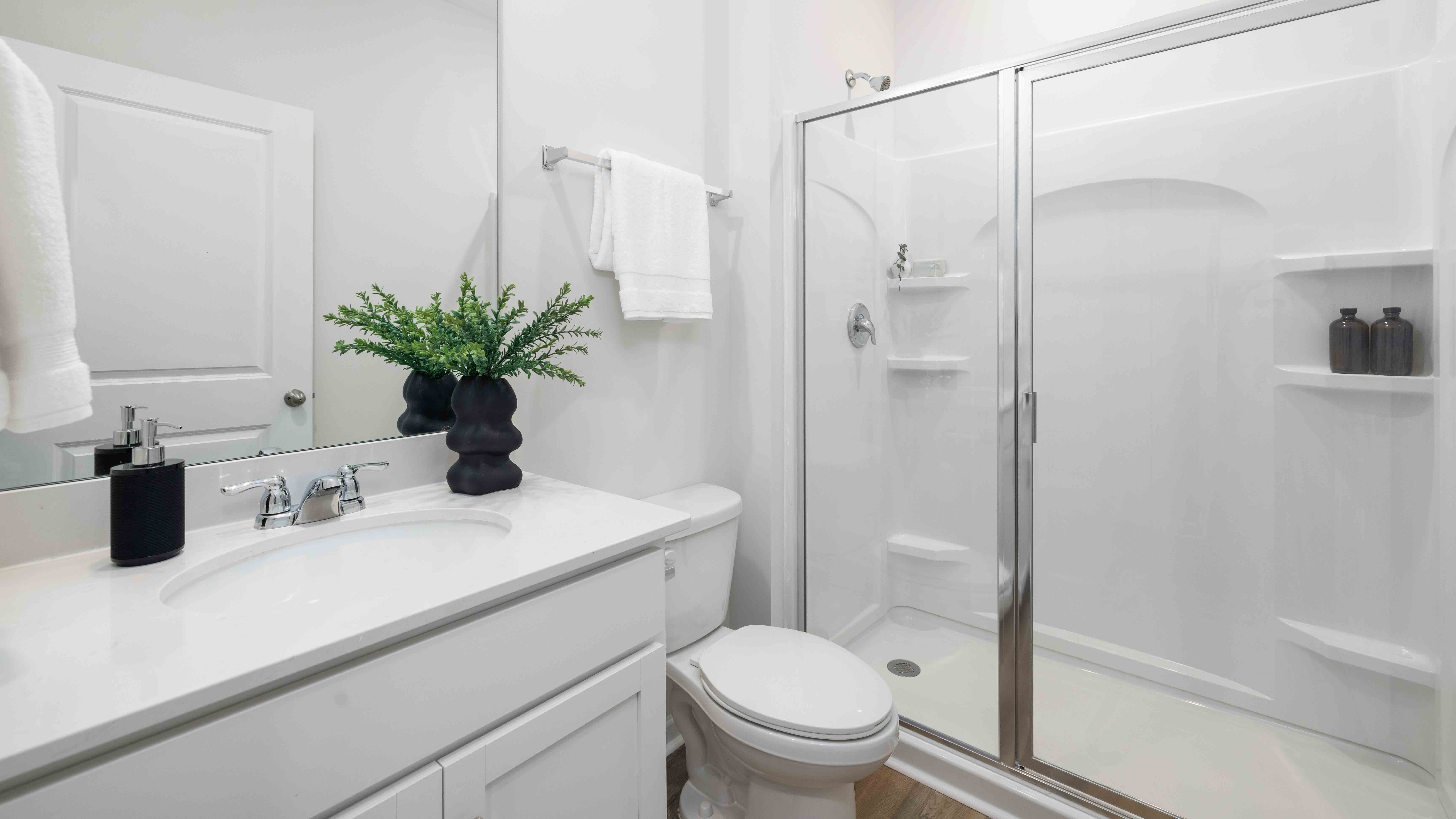 Bathroom with vanity and glass door shower