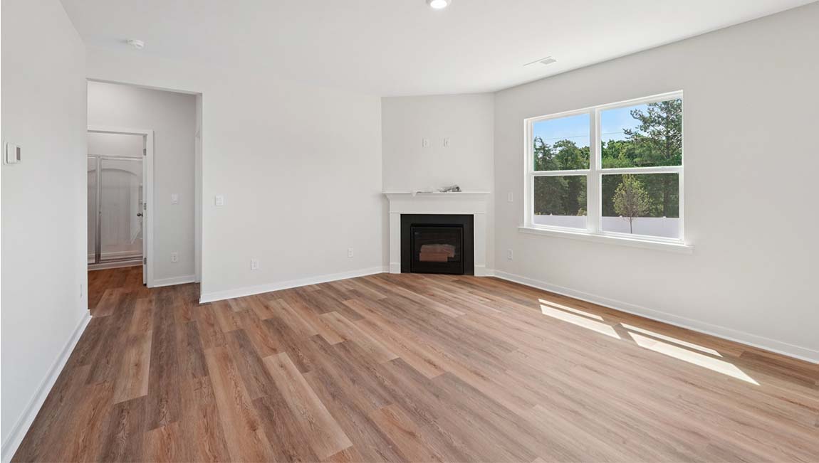 Open living area with large windows and gas fireplace