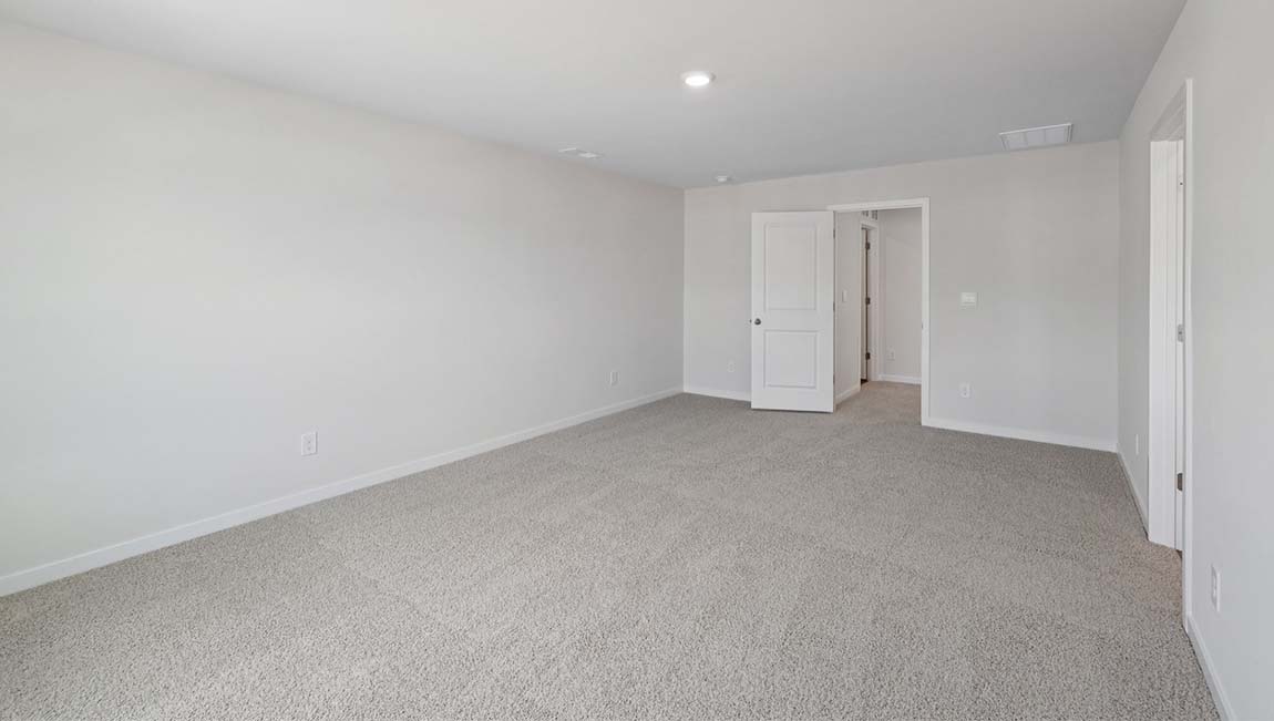 Carpeted bedroom with closet
