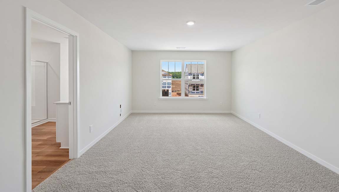 Carpeted bedroom with large windows