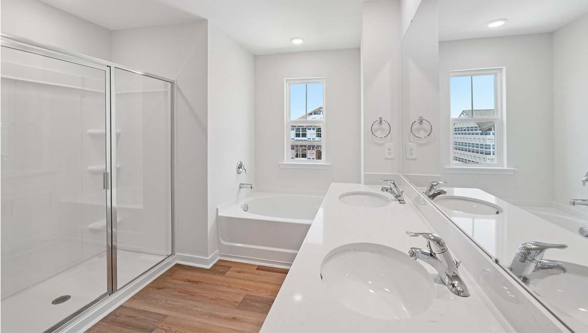 Primary bathroom with dual vanity and walk in shower