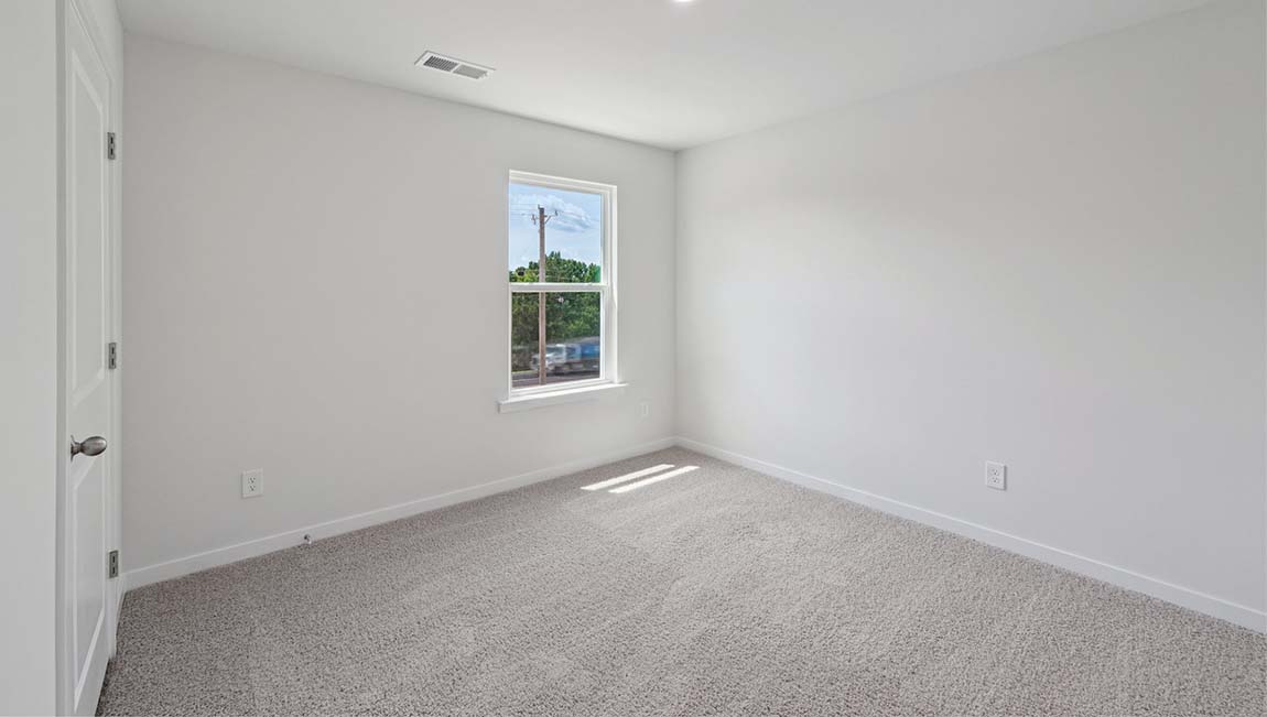 Carpeted bedroom with large window
