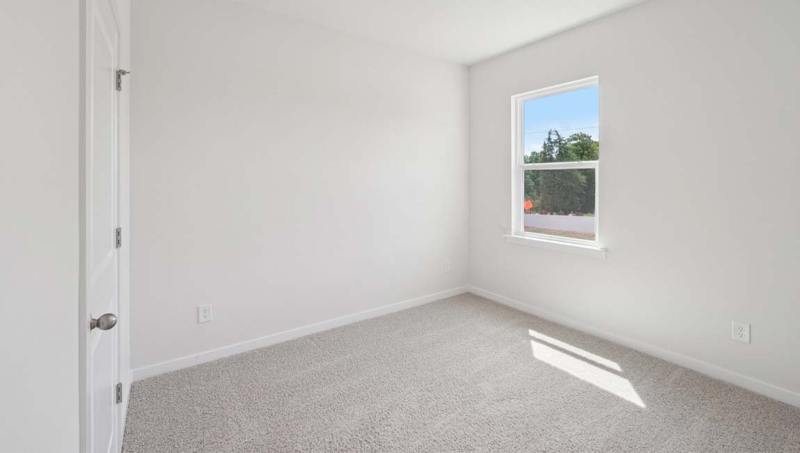 Carpeted bedroom with large window