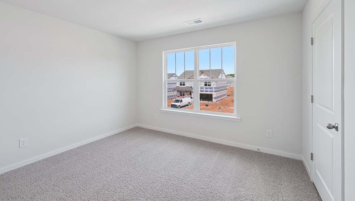 Carpeted bedroom with large window