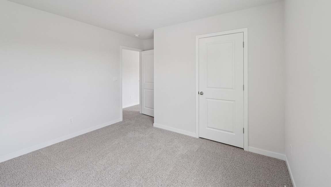 Carpeted bedroom with closet