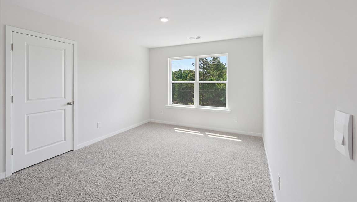 Carpeted bedroom with large window