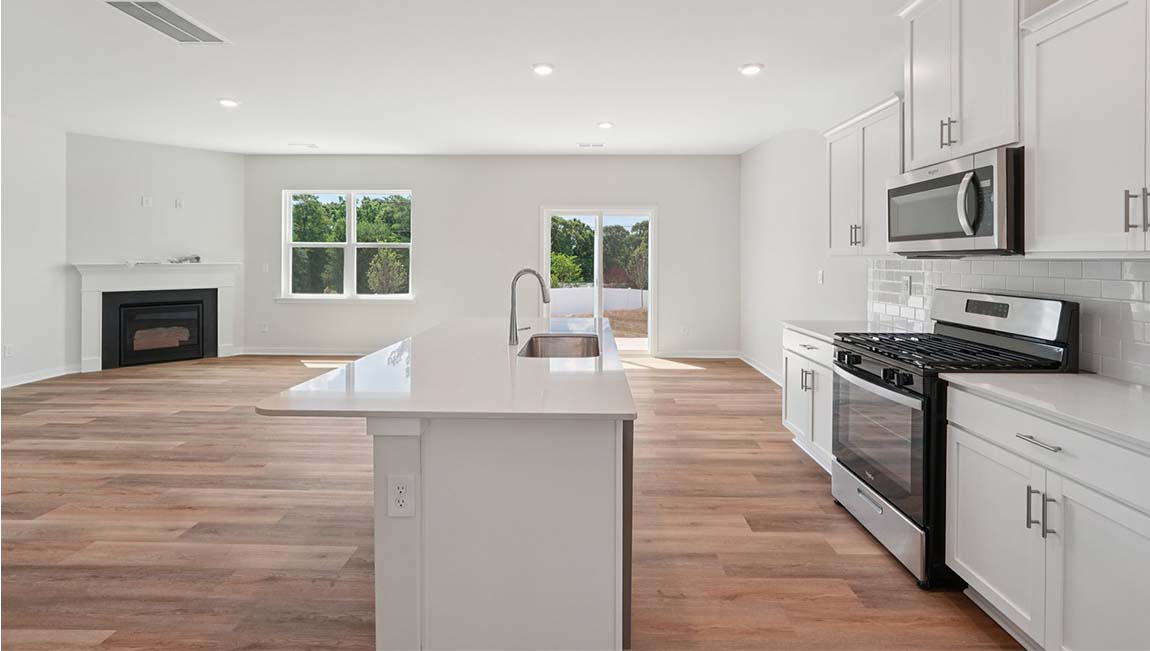 Open kitchen with stainless steel appliances and large island