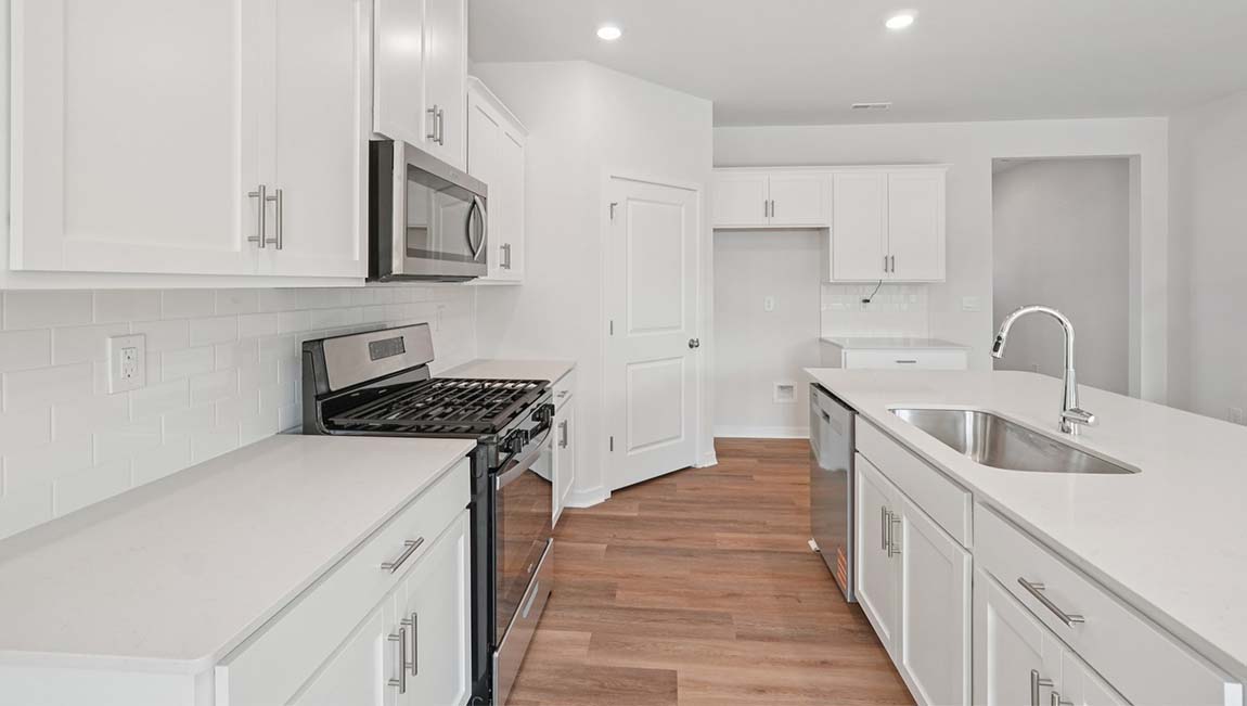 Open kitchen with stainless steel appliances and large island