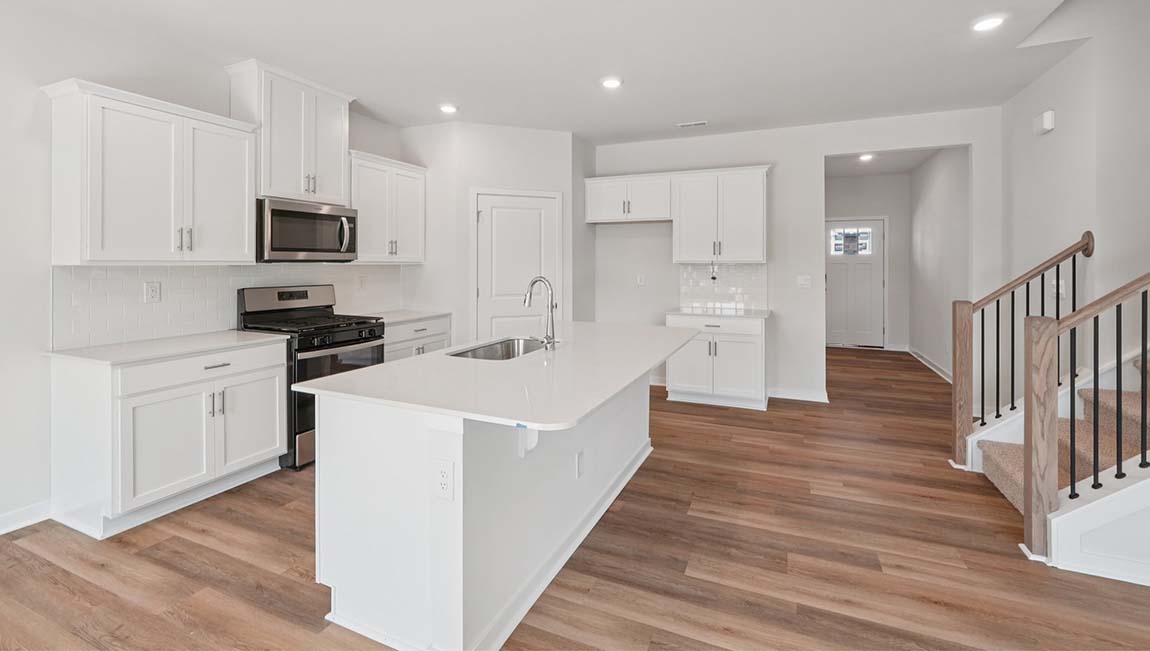 Open kitchen with stainless steel appliances and large island