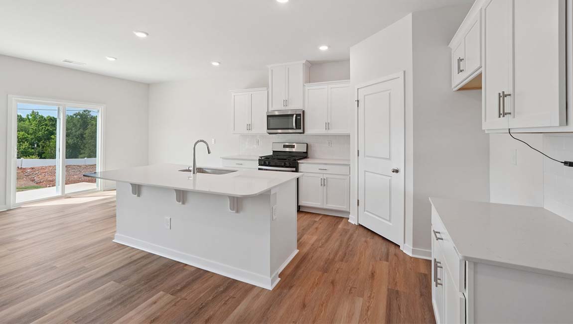 Open kitchen with stainless steel appliances and large island