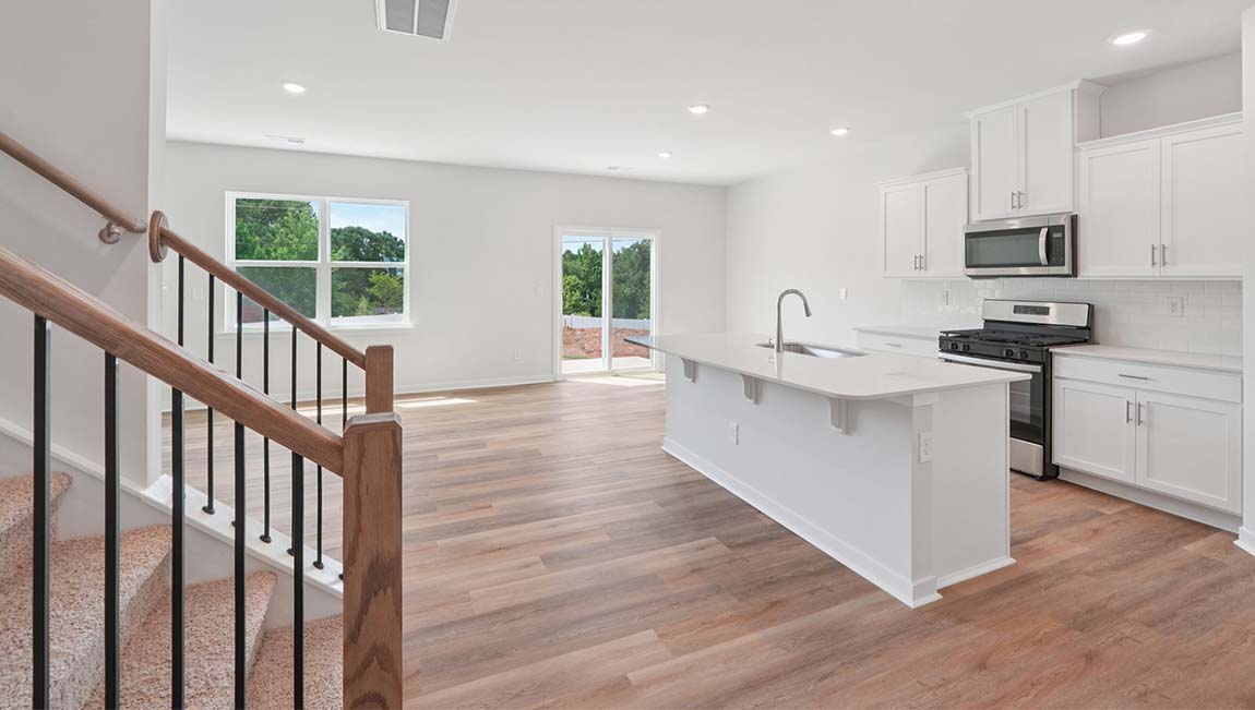 Open kitchen with stainless steel appliances and large island