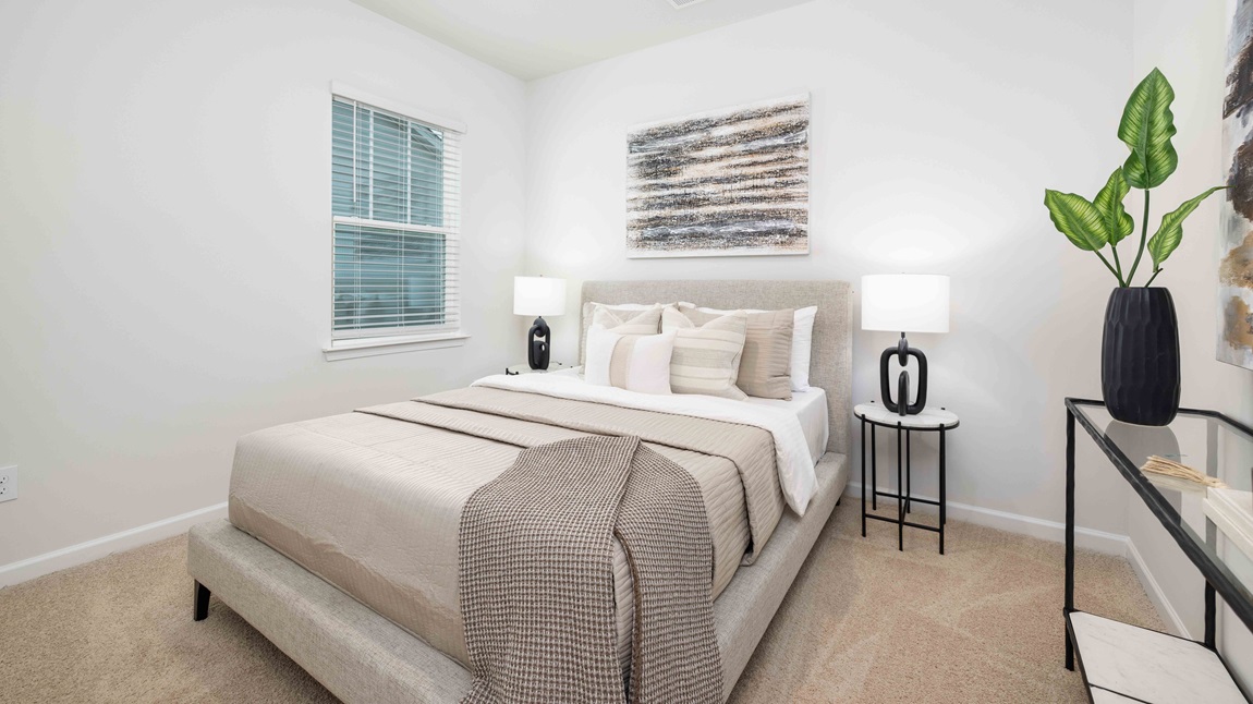 Carpeted bedroom with large window