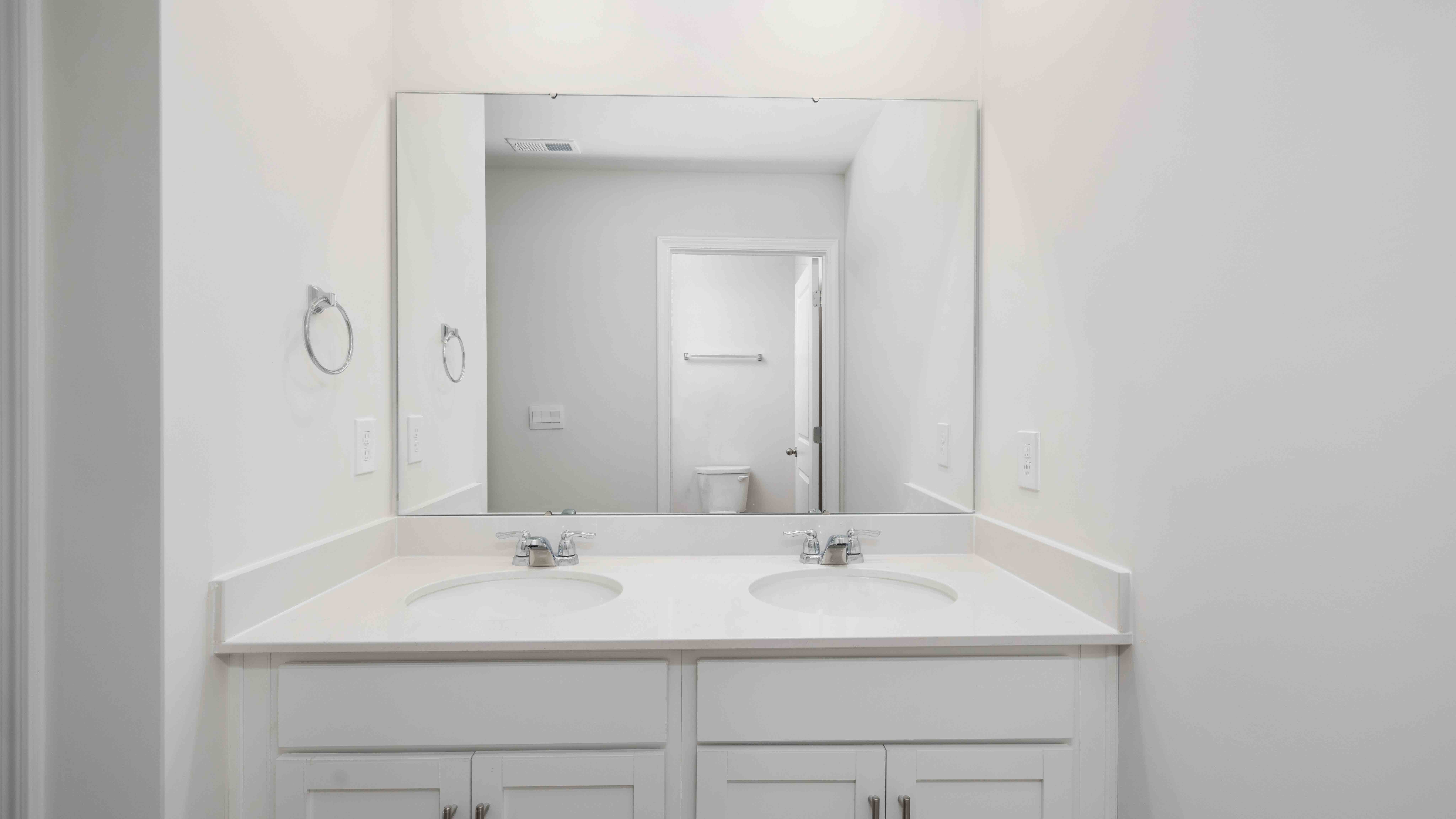 Bathroom with dual vanity and mirror