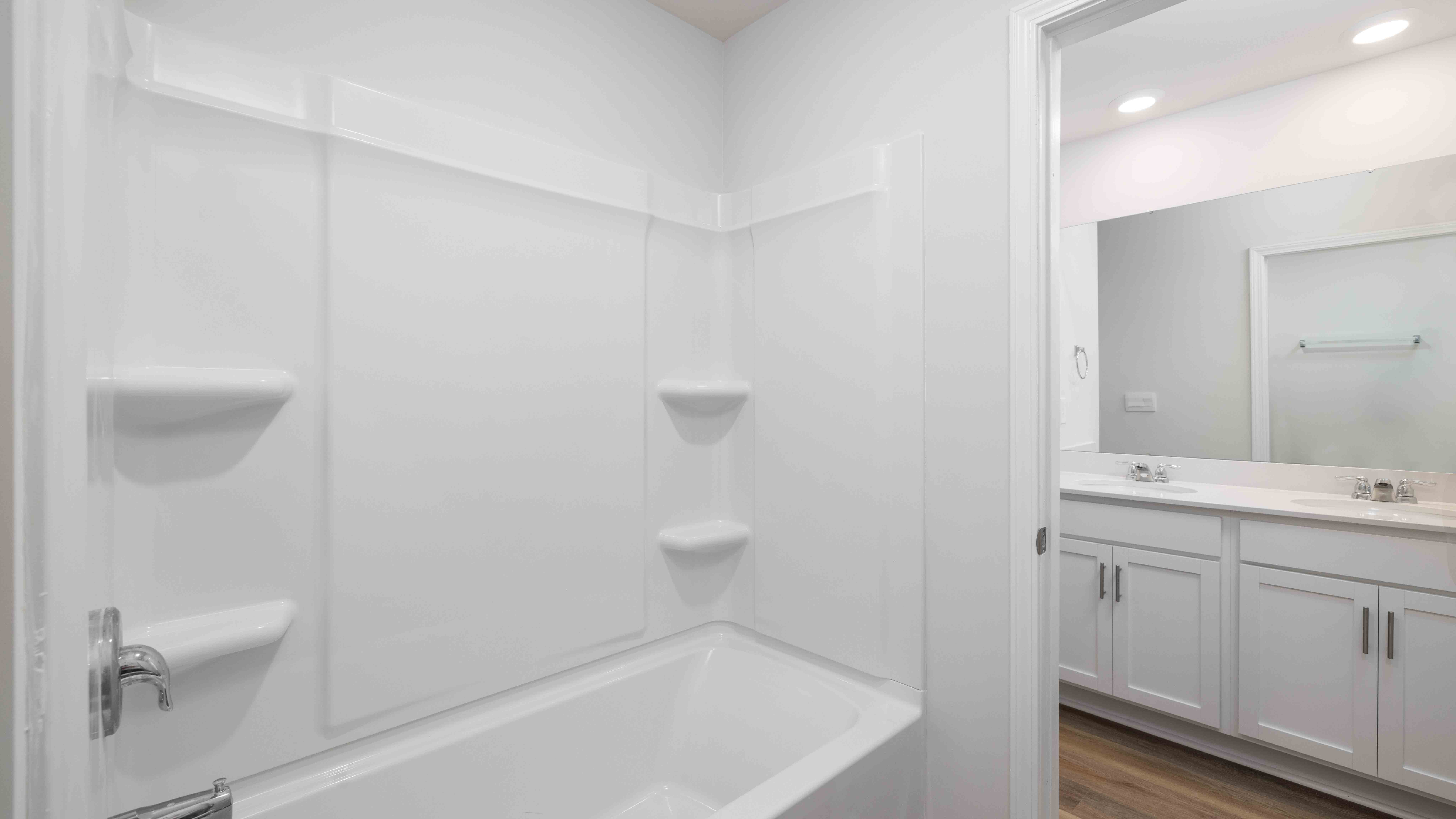 Bathroom with dual vanity and bathtub