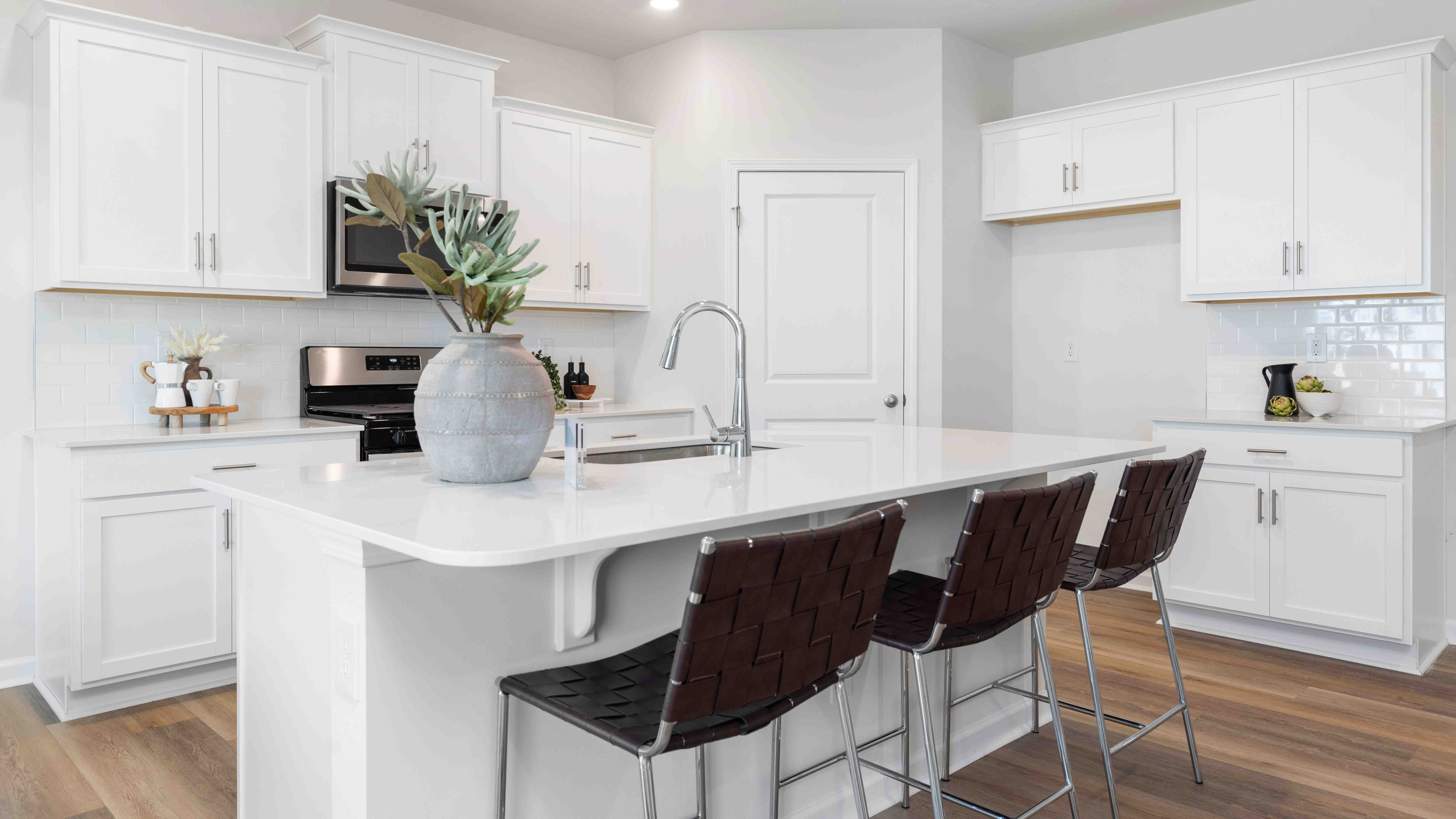 Open concept kitchen area with large island and stainless steel appliances