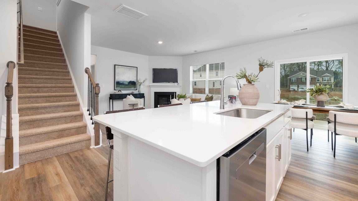 Open concept kitchen area with large island and stainless steel appliances