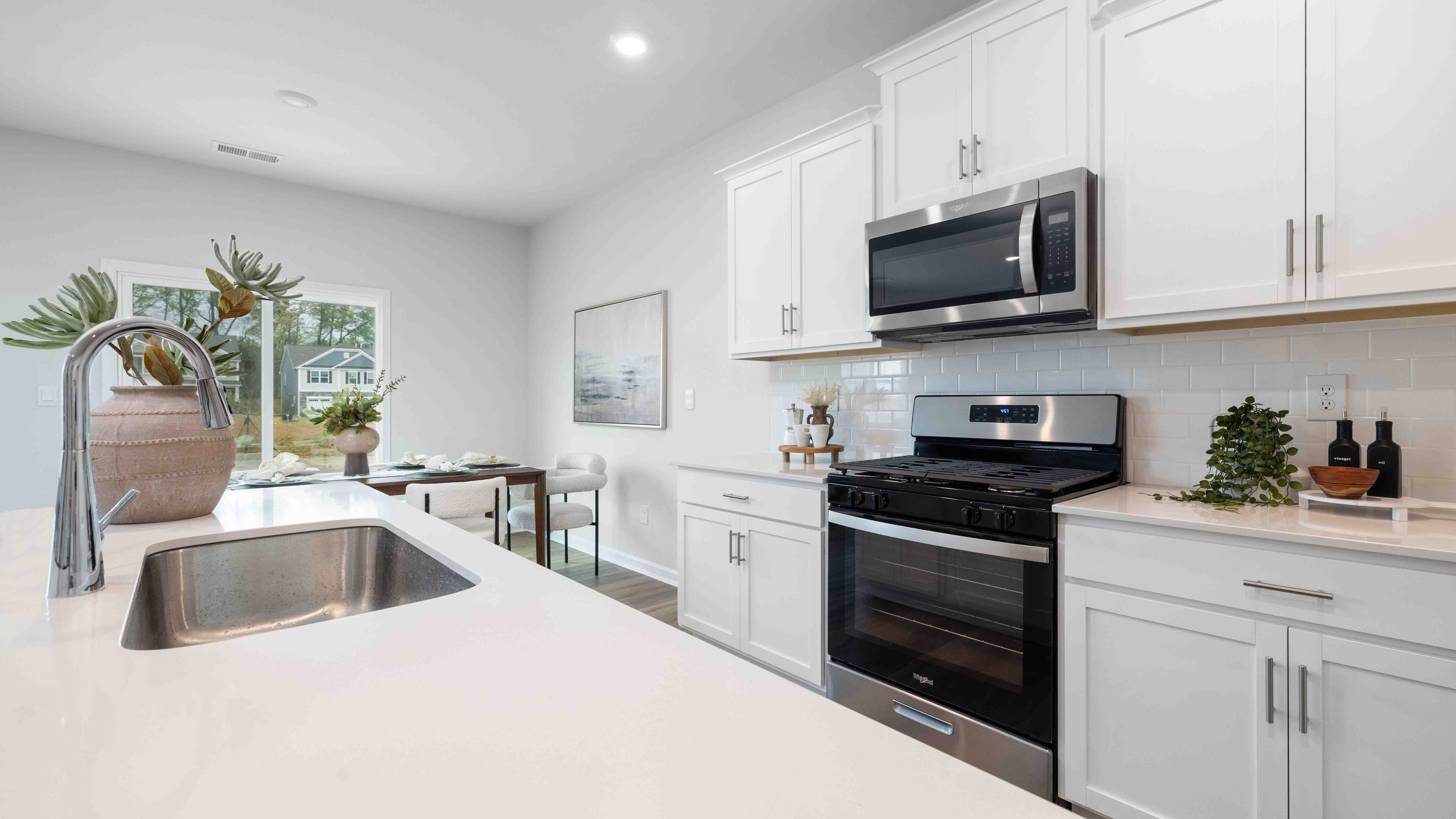 Open concept kitchen area with large island and stainless steel appliances
