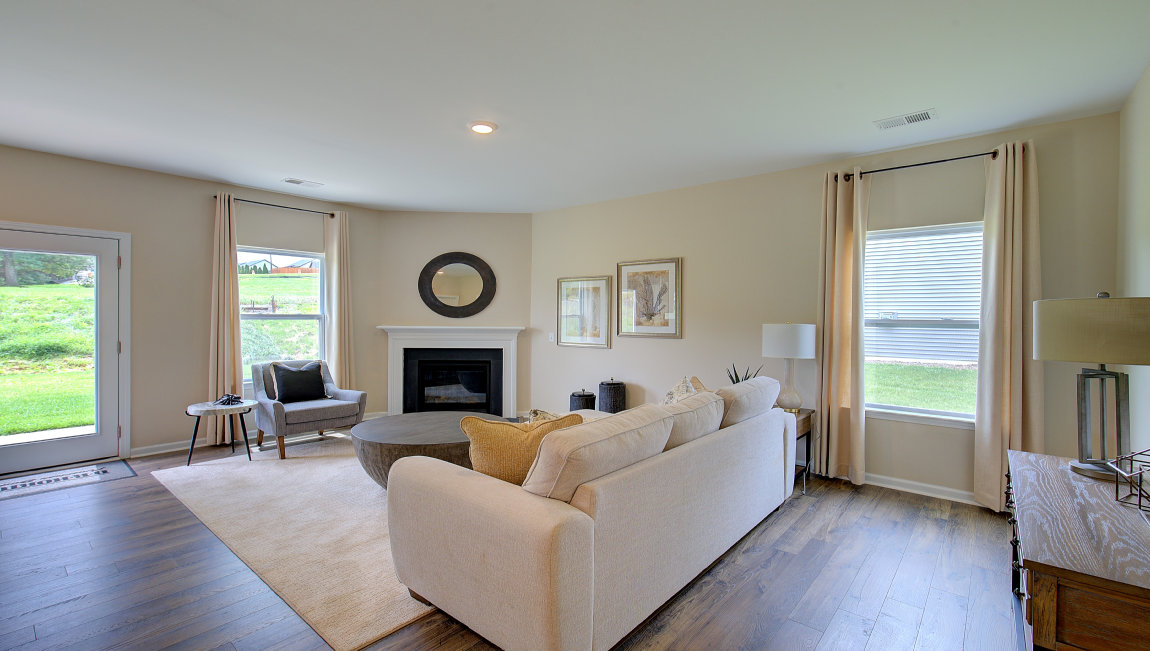 Open concept family room with fireplace and large windows