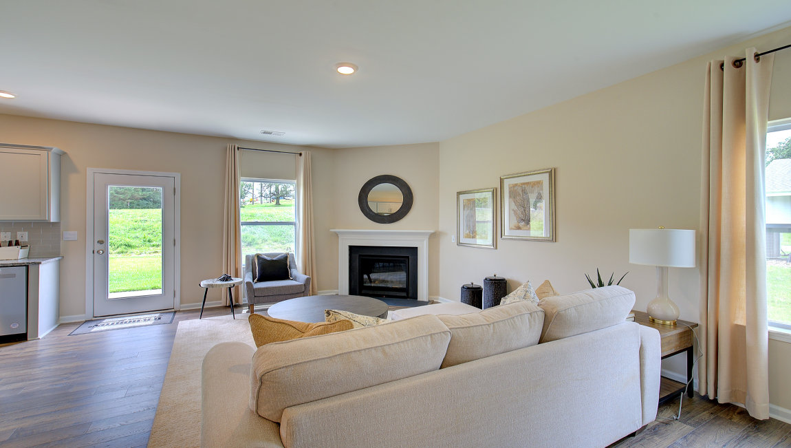 Open concept family room with fireplace and large windows