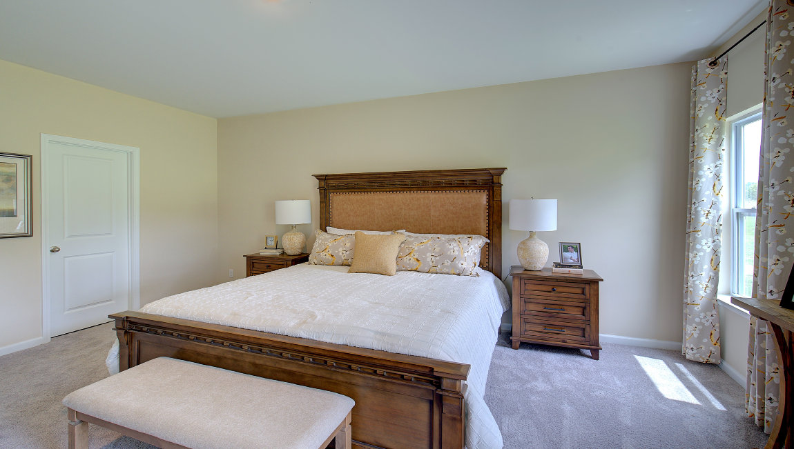 carpeted bedroom with two windows