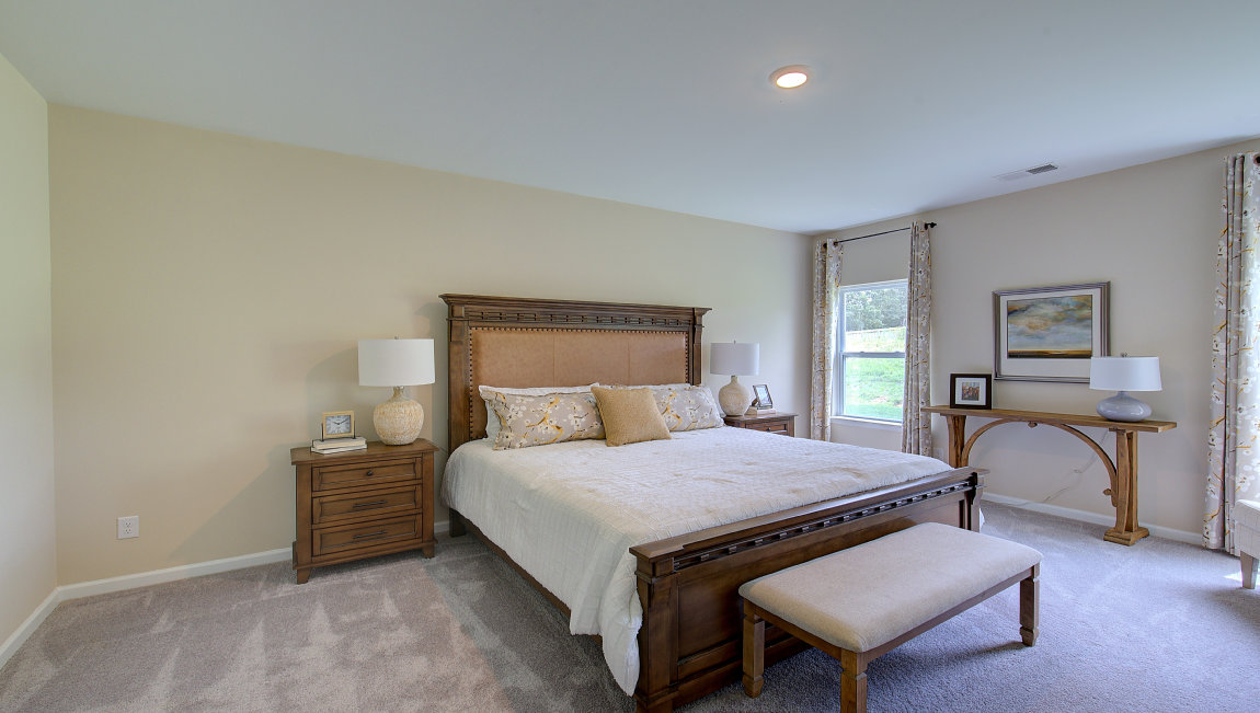 carpeted bedroom with two windows