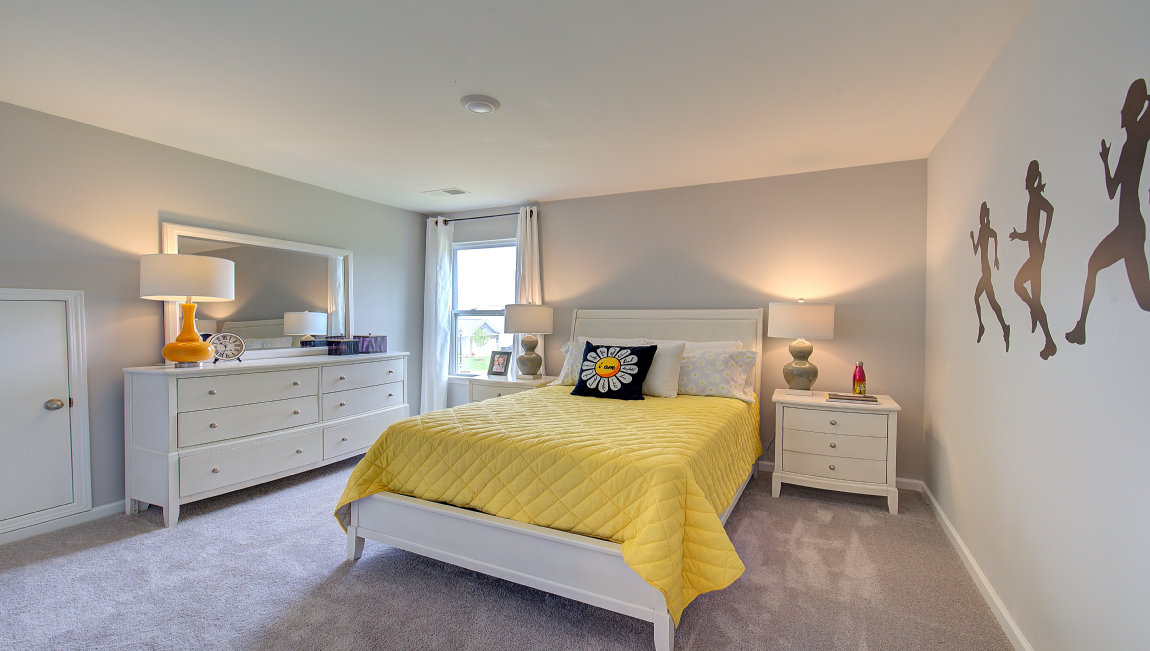 carpeted bedroom with two windows