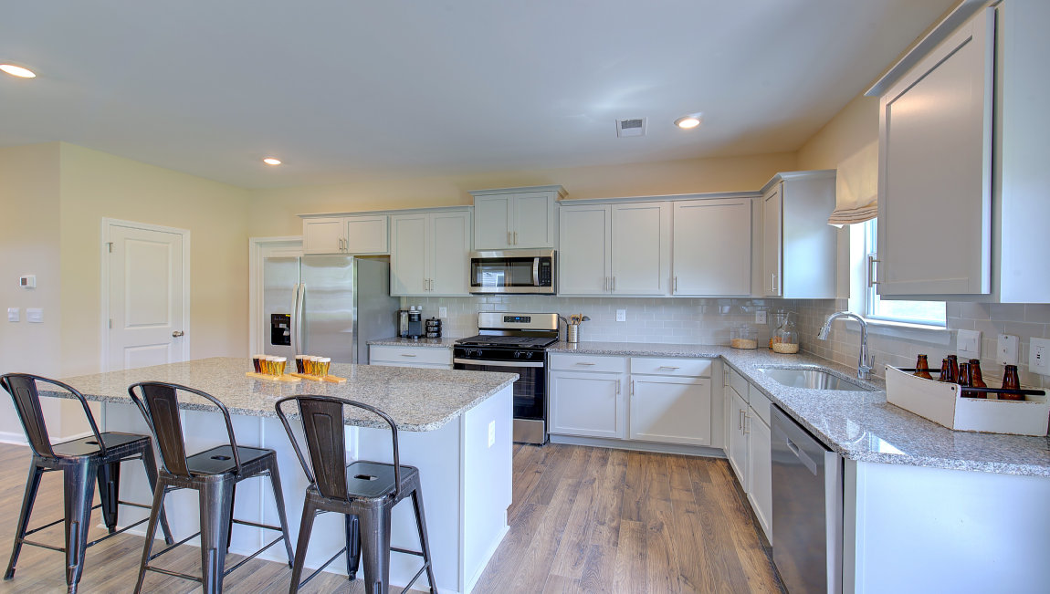 Kitchen and island with white counters and cabinets