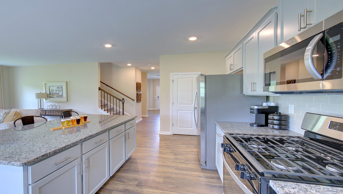 Kitchen and island with white counters and cabinets