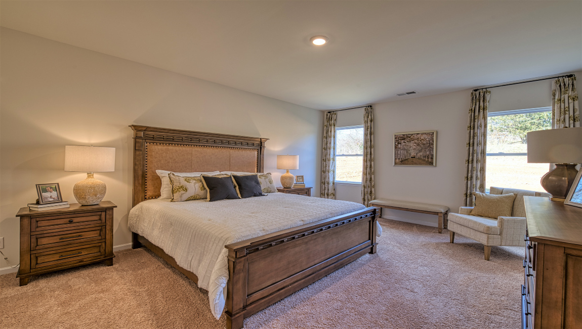Carpeted bedroom with large windows