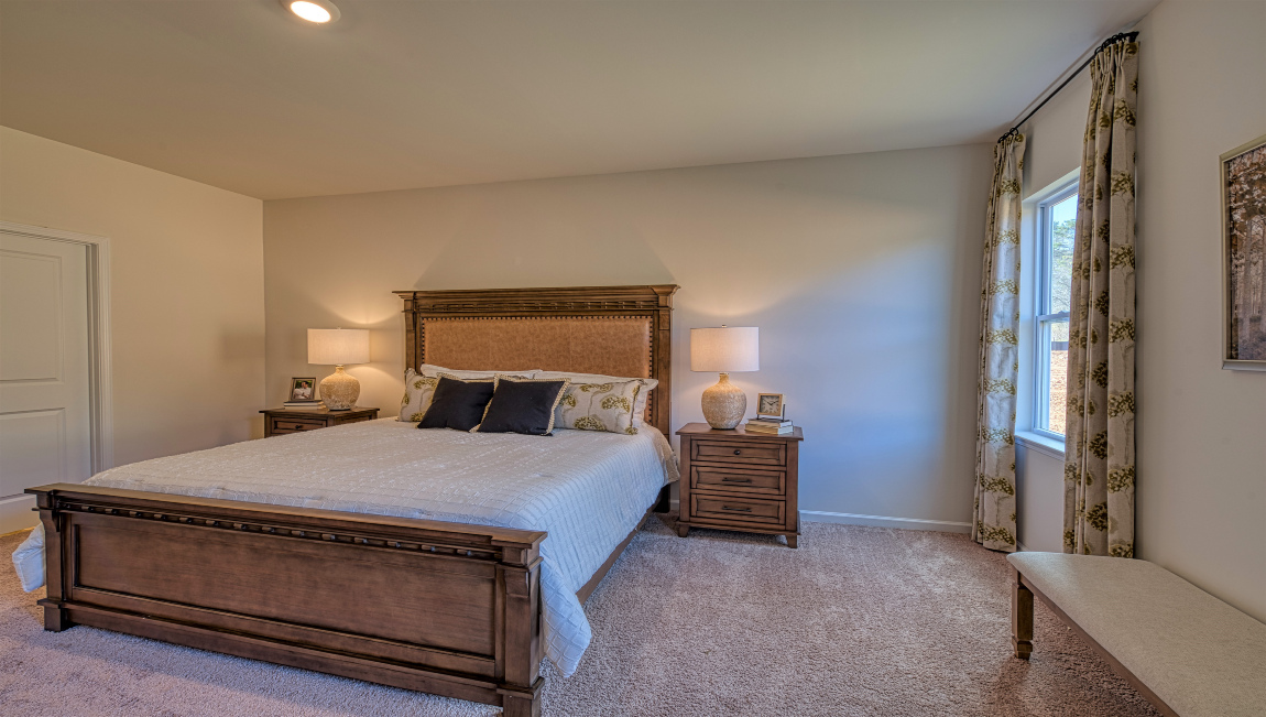 Carpeted bedroom with large windows
