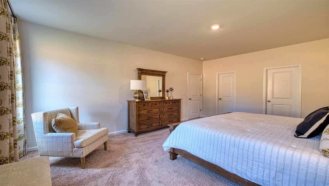 Carpeted bedroom with large windows