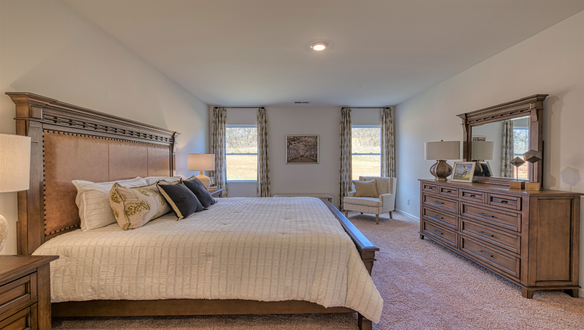 Carpeted bedroom with large windows