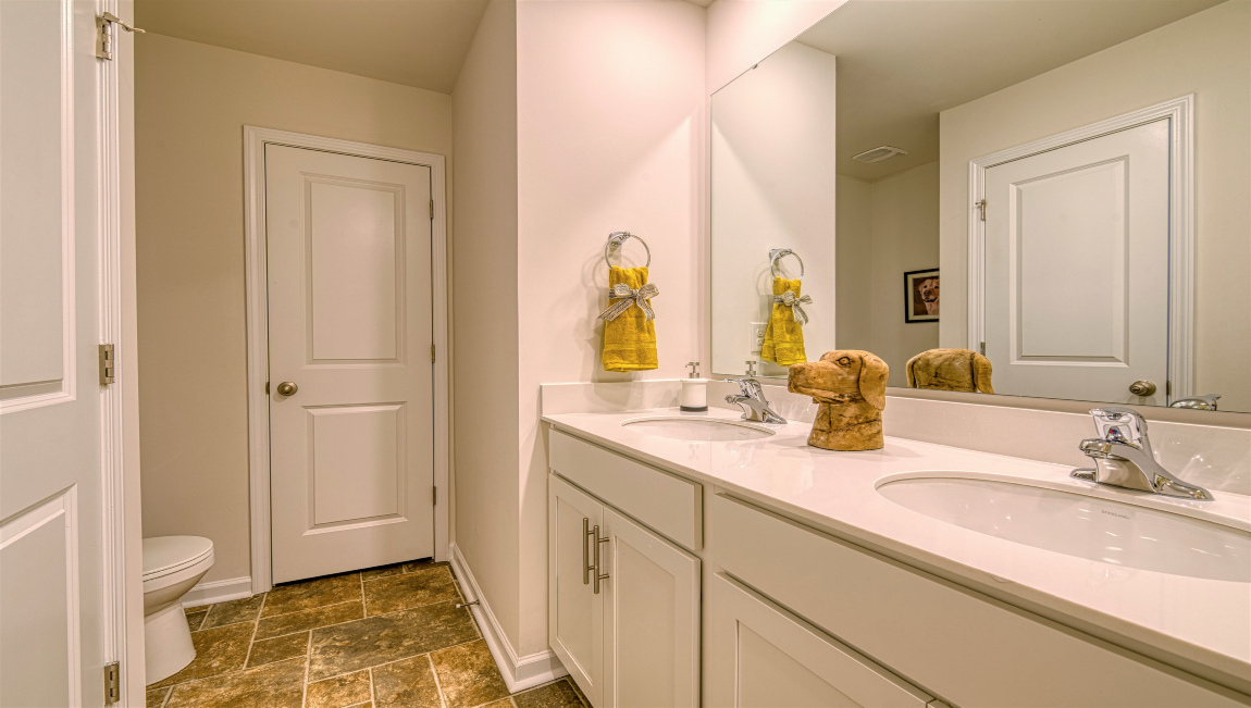 Bathroom with double vanity and toilet closet