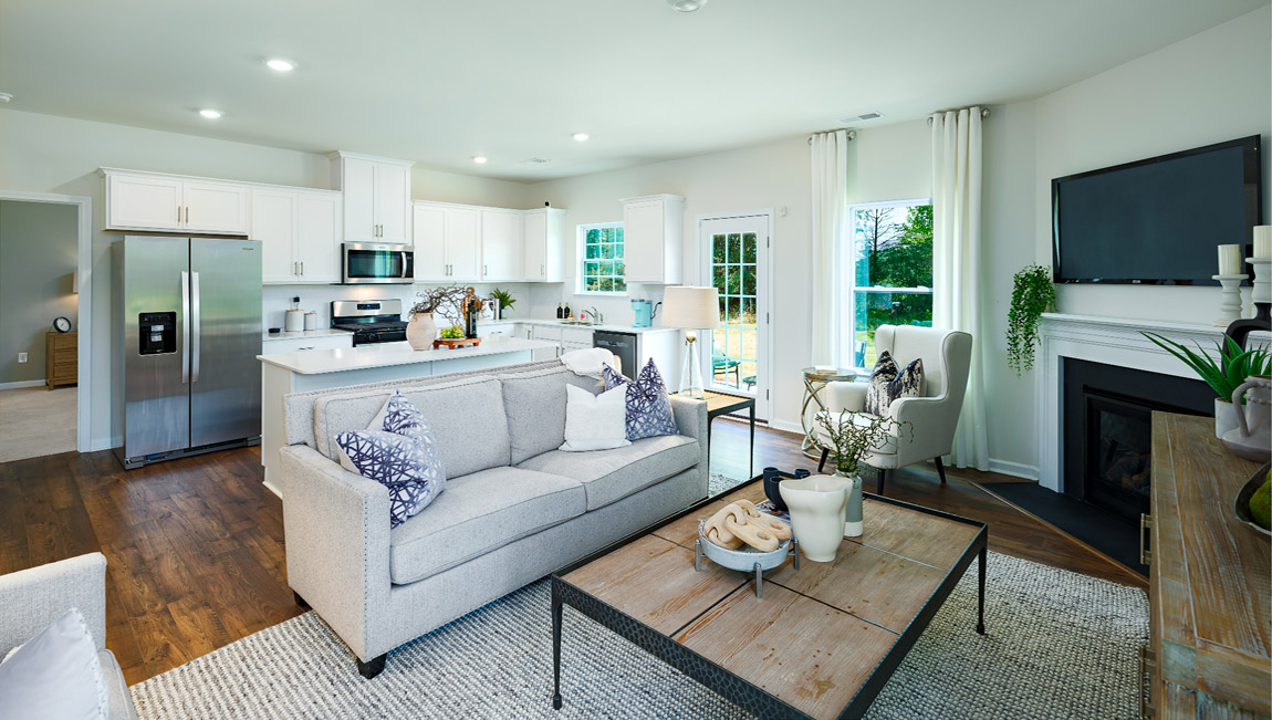 Open living area with gas fireplace and windows