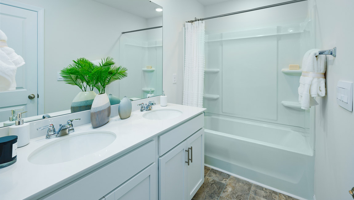 Bathroom with double vanity and bathtub