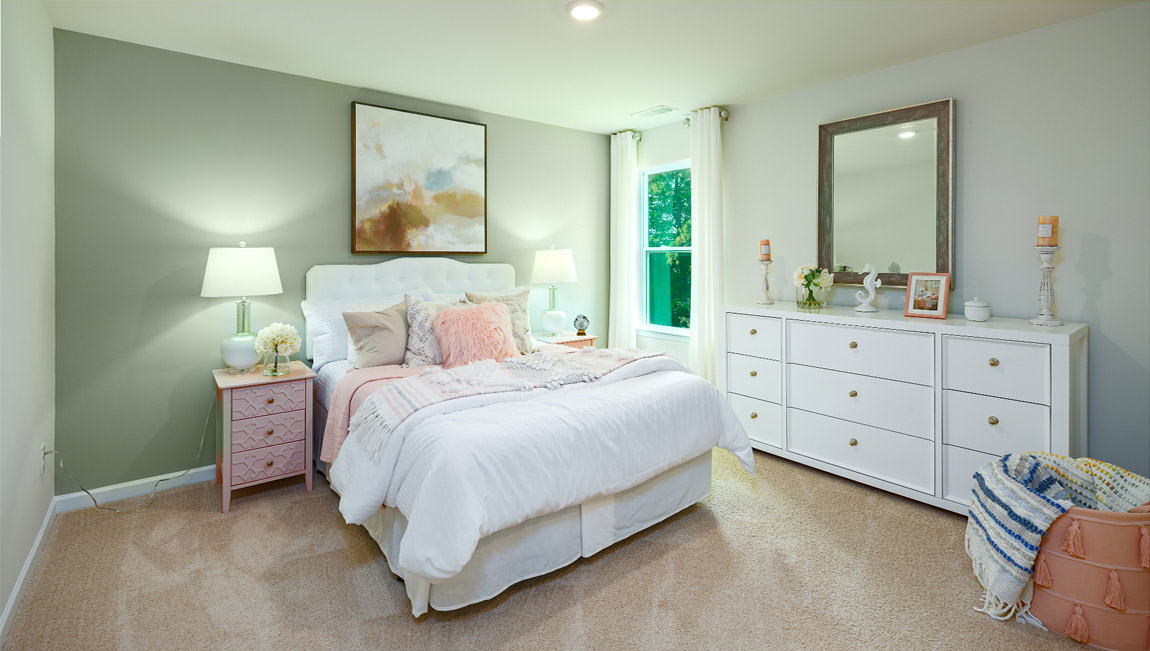 Carpeted bedroom with large windows