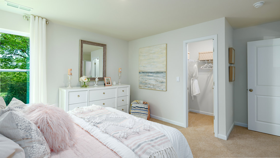 Carpeted bedroom with large windows