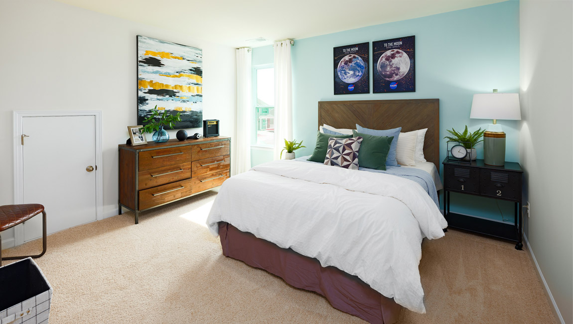 Carpeted bedroom with large windows